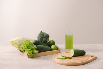 Vegan diet food. Detox drinks. Freshly squeezed juices and smoothies from vegetables. On white background, wooden tray, ingredients. Copy space