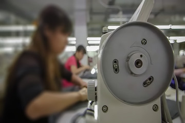 Abstract, blur, bokeh background, defocusing - image for the background. People work in the clothing industry.