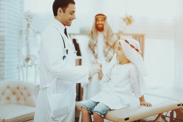 Arabic Doctor Giving Medicine to Sick Little Boy