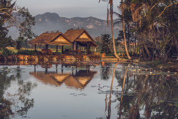 Obraz premium Two gazebos near the pond with mountain view in Luang Prabang, Laos