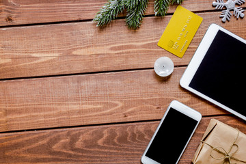 smartphone, tablet, shopping for new year online wooden table