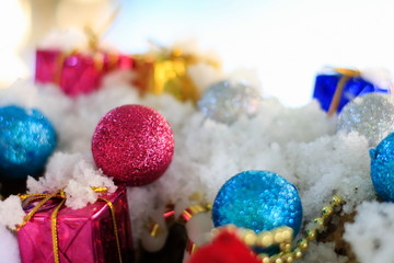 Snow man with a Christmas ornament on a snow background blur.