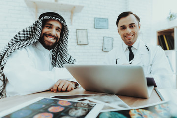Muslim Patient and Smiling Doctor Looking Camera