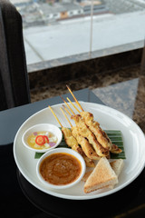 Satay is a dish of seasoned, skewered and grilled meat, Grilled chicken meat satay with sweet sauce - Thai food style