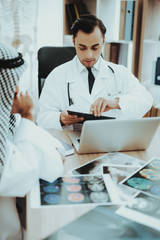 Portrait of Doctor Consulting Arabic Man Hospital