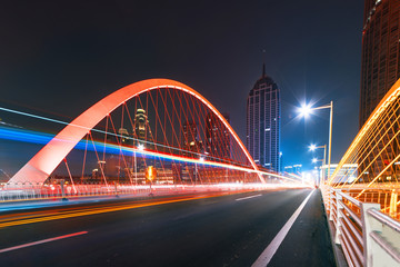 abstract image of blur motion of cars on the city road at night，Modern urban architecture in...