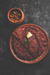 Ragi Roti made from finger millet from India is extremely rich in proteins served with pickle or achar. selective focus