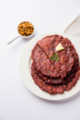 Ragi Roti made from finger millet from India is extremely rich in proteins served with pickle or achar. selective focus