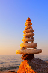 Stones balance on a background of sea sunset. Concept of harmony and balance