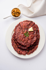 Ragi Roti made from finger millet from India is extremely rich in proteins served with pickle or achar. selective focus