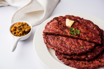 Ragi Roti made from finger millet from India is extremely rich in proteins served with pickle or achar. selective focus