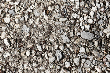 the texture of the old asphalt with pebbles and cracks