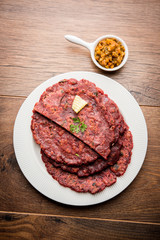 Ragi Roti made from finger millet from India is extremely rich in proteins served with pickle or achar. selective focus