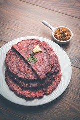 Ragi Roti made from finger millet from India is extremely rich in proteins served with pickle or achar. selective focus