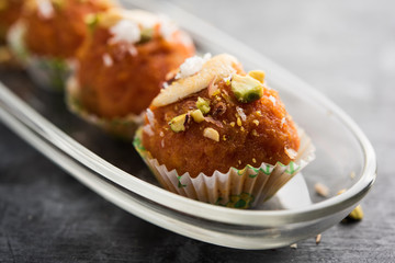 Carrot Halwa Laddu or sweet balls,  served in a plate with dry fruits toppings. selective focus