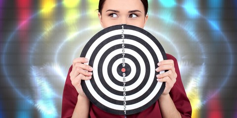 Beautiful businesswoman portrait holding round target of darts