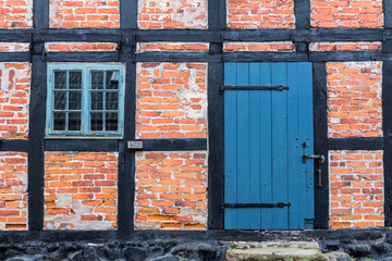 Fototapeta na wymiar Old architecture blue doors detail in Ystad in Sweden