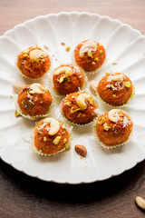 Carrot Halwa Laddu or sweet balls,  served in a plate with dry fruits toppings. selective focus