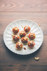 Carrot Halwa Laddu or sweet balls,  served in a plate with dry fruits toppings. selective focus