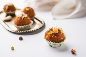 Carrot Halwa Laddu or sweet balls,  served in a plate with dry fruits toppings. selective focus
