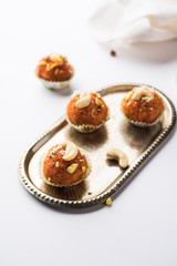Carrot Halwa Laddu or sweet balls,  served in a plate with dry fruits toppings. selective focus