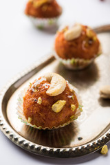 Carrot Halwa Laddu or sweet balls,  served in a plate with dry fruits toppings. selective focus