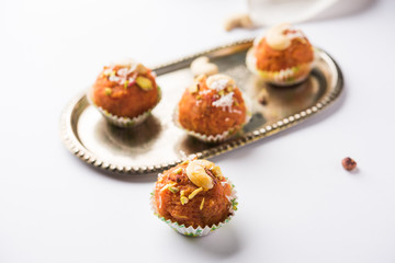 Carrot Halwa Laddu or sweet balls,  served in a plate with dry fruits toppings. selective focus