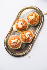 Carrot Halwa Laddu or sweet balls,  served in a plate with dry fruits toppings. selective focus