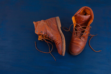 old boot red brown shoes blue top view background red leather laces high canvas dirty