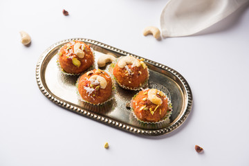 Carrot Halwa Laddu or sweet balls,  served in a plate with dry fruits toppings. selective focus