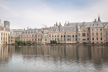 Fototapeta na wymiar Amazing Binnenhof Palace in The Hague (Den Haag). Dutch Parliament buildings. Famous castle with fountains in front of it. The Netherlands, The Hague. 