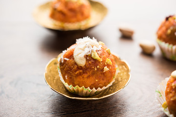 Carrot Halwa Laddu or sweet balls,  served in a plate with dry fruits toppings. selective focus