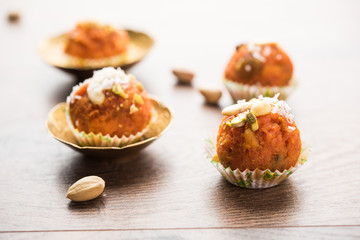 Carrot Halwa Laddu or sweet balls,  served in a plate with dry fruits toppings. selective focus