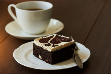 A piece of chocolate cake on wooden table