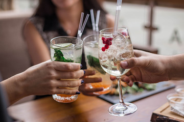 Group of friends having fun and drink cocktails. Cheers glasses in the hands. Summer mood in Minsk, Belarus.vk