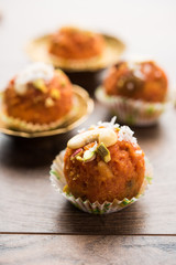 Carrot Halwa Laddu or sweet balls,  served in a plate with dry fruits toppings. selective focus