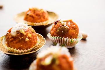 Carrot Halwa Laddu or sweet balls,  served in a plate with dry fruits toppings. selective focus