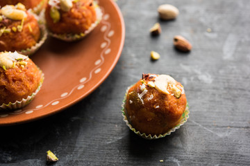 Carrot Halwa Laddu or sweet balls,  served in a plate with dry fruits toppings. selective focus