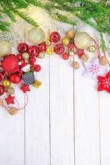 Fir branches, decorations, golden and red Christmas balls on white rustic wooden background. Christmas holiday concept, festive winter season, Advent time. template for design. top view. copy space 