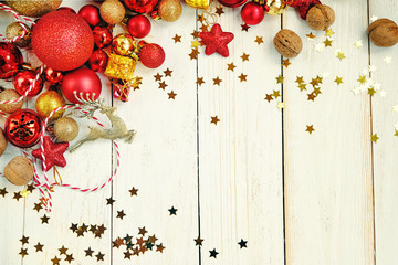 deer toy, Fir branches, decorations, golden and red Christmas balls on white rustic wooden background. Christmas holiday concept, festive winter season, Advent time. template for design. copy space 