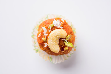 Carrot Halwa Laddu or sweet balls,  served in a plate with dry fruits toppings. selective focus