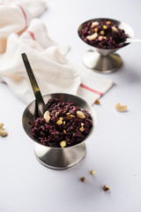 Fototapeta na wymiar Beetroot Halwa garnished with Pistachio served in a bowl, selective focus