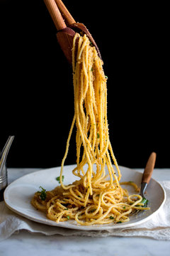 Close up of pasta with garlicky breadcrumbs and anchovies serving on plate