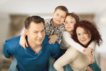Fototapeta premium Beautiful smiling family sitting at sofa