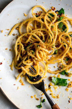 Close up of pasta with garlicky breadcrumbs and anchovies serve on plate