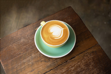 cup of coffee on black rustic background with beautiful latte art