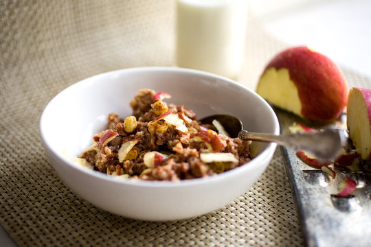 Oatmeal and teff with cinnamon and dried fruit served in bowl