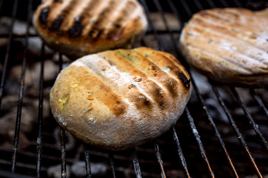Close up of grilled flatbread on barbecue grill