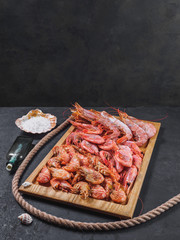 Frozen raw tiger royal shrimps on the wooden board