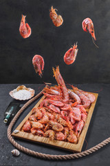 Frozen raw tiger royal shrimps on the wooden board